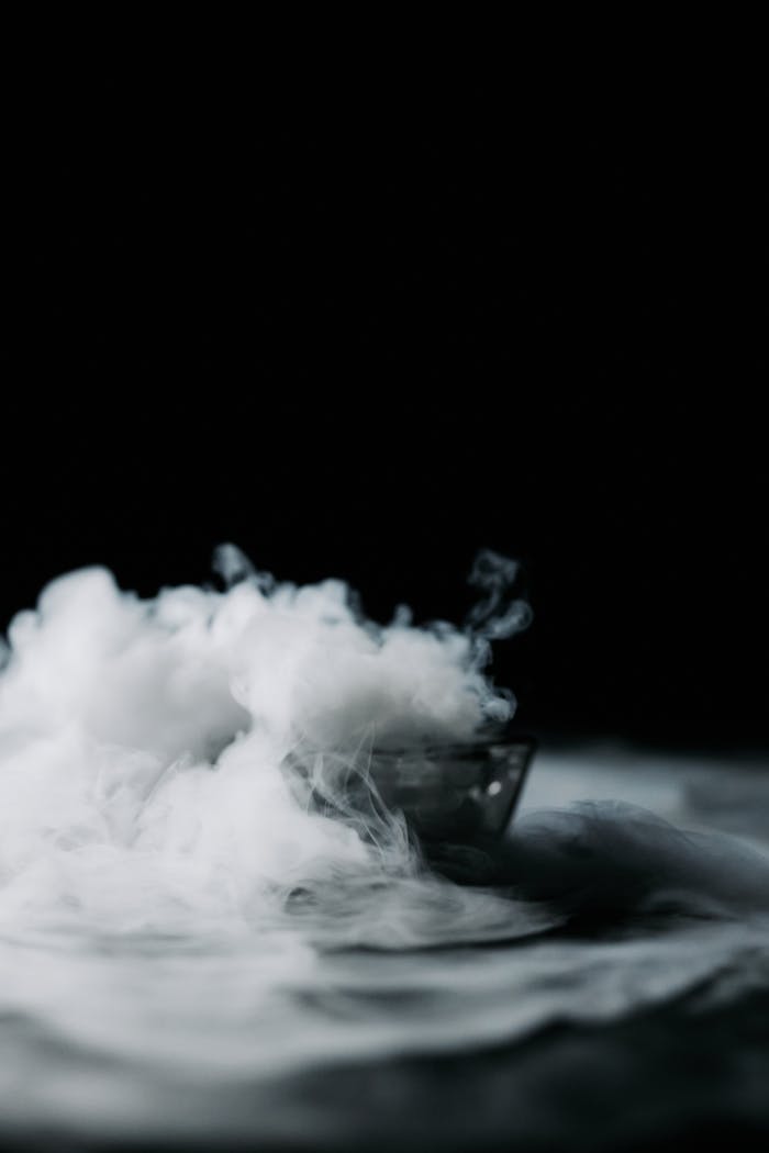 A mysterious smoke effect on a dark background, creating an artistic and dramatic visual.